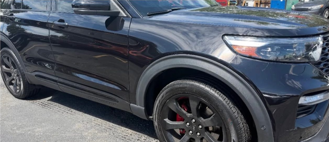 The same Ford Explorer ST with the lower body repaired and refinished.