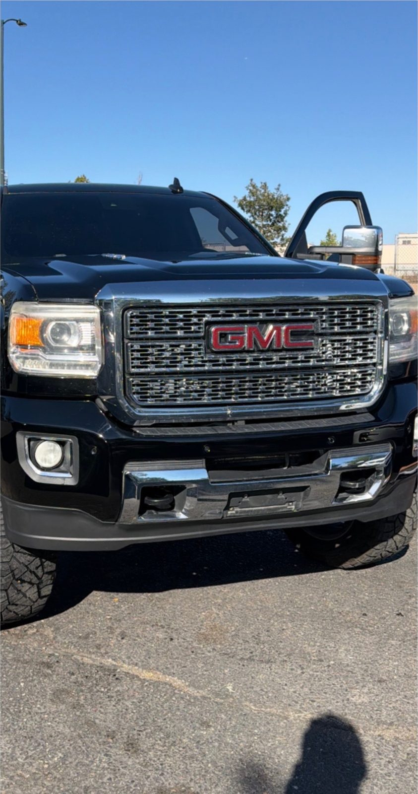 The same GMC Sierra Denali with the front bumper and grille rebuilt.