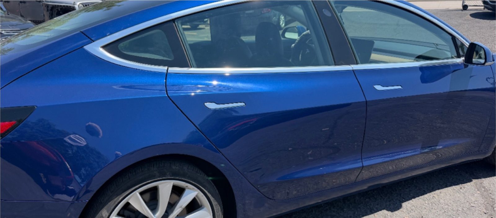 The same Tesla Model 3 with the side rebuilt and the paint matched.